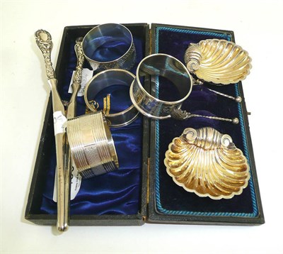 Lot 453 - Pair of cased silver shell dishes, four silver napkin rings and pair of silver mounted glove...