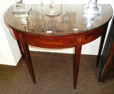 Lot 529 - A George III mahogany broad D section side table cross banded in rosewood with glass protector