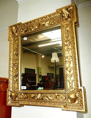 Lot 530 - A 19th century gilt rectangular mirror, each corner decorated with a head