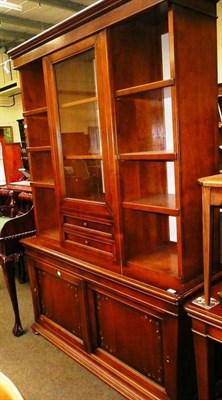 Lot 559 - A reproduction mahogany Le Fablier glazed and open bookcase with cupboards below