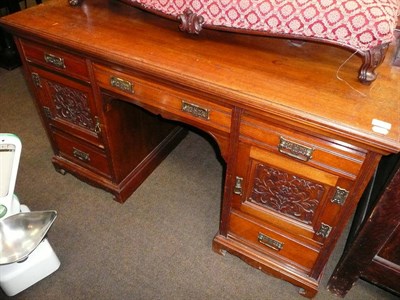 Lot 565 - A late Victorian carved walnut kneehole desk converted from a sideboard