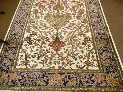 Lot 574 - A cream ground rug with floral and bird motifs with Lahor label