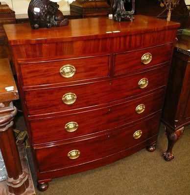 Lot 578 - An early 19th century mahogany bow front chest of two short and three long graduated drawers