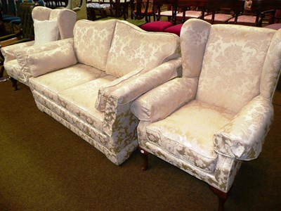 Lot 592 - A pair of wing back armchairs and a two seater sofa