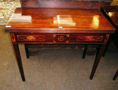 Lot 609 - A late George III mahogany fold over tea table