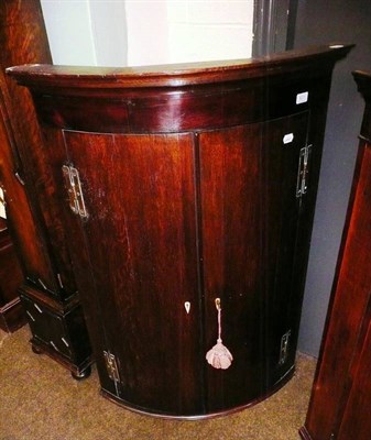 Lot 631 - George III oak/mahogany corner cupboard