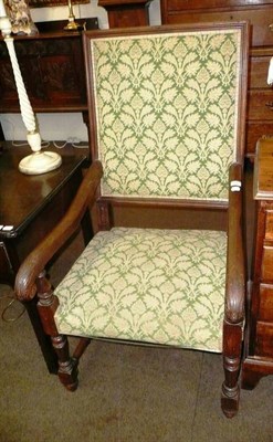 Lot 644 - A 17th century style carved oak open arm elbow chair with green damask upholstery