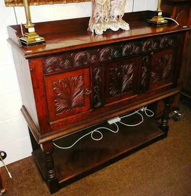 Lot 652 - A carved oak cupboard on stand