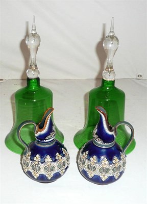 Lot 50 - A pair of green glass bells and two Doulton Lambeth jugs