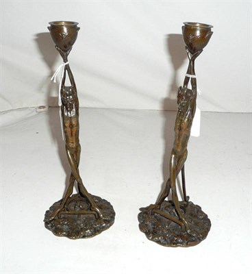 Lot 66 - A pair of continental bronze devil candlesticks