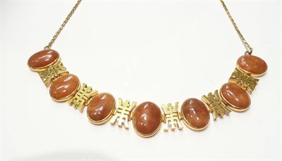 Lot 118 - A 22ct gold `red amber' jade necklace