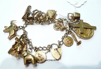 Lot 136 - A gold charm bracelet set with a Victorian 1893 sovereign and a small quantity of loose charms,...