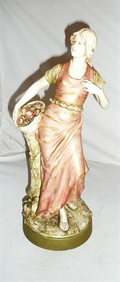 Lot 180 - A Royal Dux figure of a maiden holding a basket of flowers