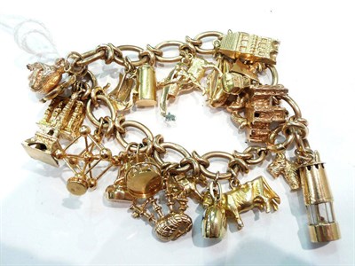 Lot 272 - A 9ct gold charm bracelet hung with twenty four assorted charms, 74g gross