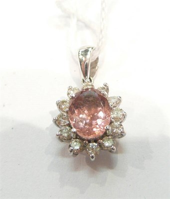 Lot 274 - A pink topaz and diamond cluster pendant, stamped 'K18'