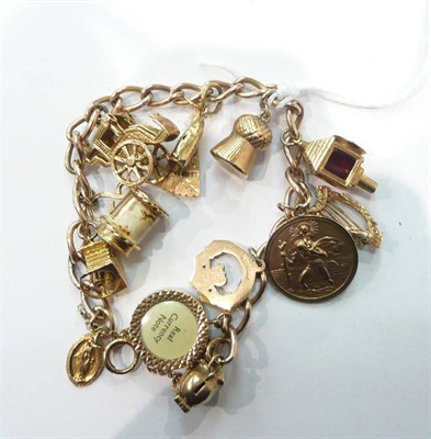 Lot 286 - A 9ct gold charm bracelet suspending thirteen assorted charms, 50g gross