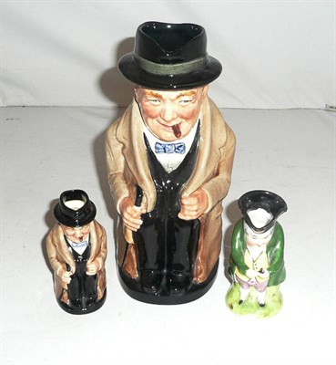 Lot 304 - A Royal Doulton Winston Churchill jug and another smaller version and a small toby jug