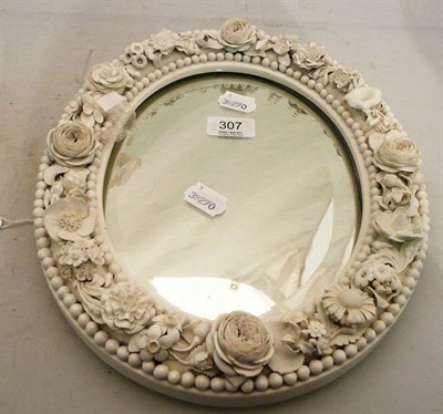 Lot 307 - A white flower encrusted porcelain oval mirror frame