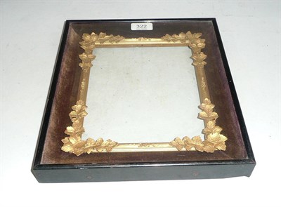 Lot 322 - A glazed frame with a carved insert