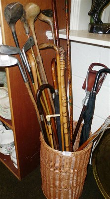 Lot 346 - A stick stand with assorted canes, golf clubs, etc also a prayer rug