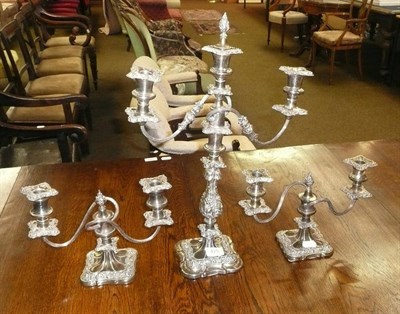 Lot 425 - A pair of plated three branch candelabra and another, larger