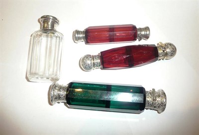 Lot 449 - A green glass double ended scent bottle, two cranberry glass examples and a clear glass scent...