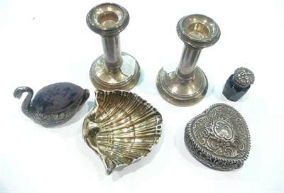 Lot 456 - Pair of silver dwarf candlesticks, silver shell salt, pin cushion and a heart-shaped trinket box