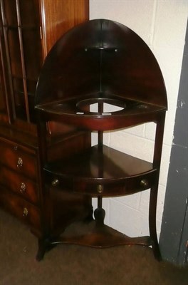 Lot 545 - A George lll bow front corner washstand