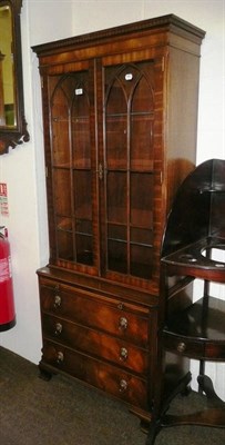 Lot 546 - A reproduction small glazed bookcase on chest