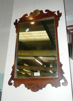 Lot 553 - A mahogany fret carved wall mirror with shell pediment