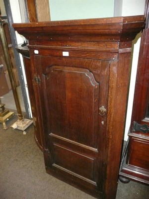 Lot 557 - Panelled oak corner cupboard