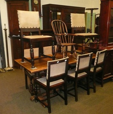 Lot 561 - A small oak refectory style dining table and eight chairs