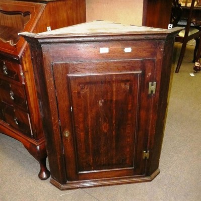 Lot 572 - A George III oak straight front hanging corner cupboard