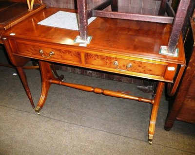 Lot 576 - A reproduction yew wood sofa table