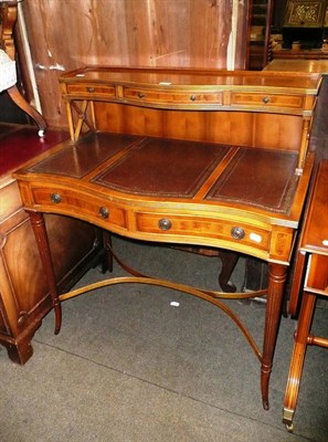 Lot 577 - A reproduction yew wood serpentine front desk