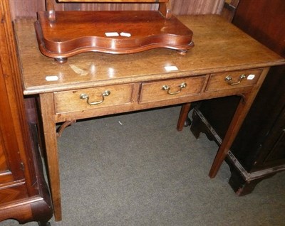 Lot 585 - A George lll mahogany three drawer side table