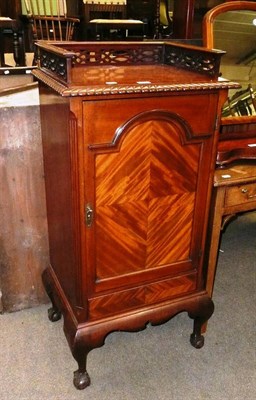 Lot 586 - A mahogany sheet music cabinet with fret carved gallery