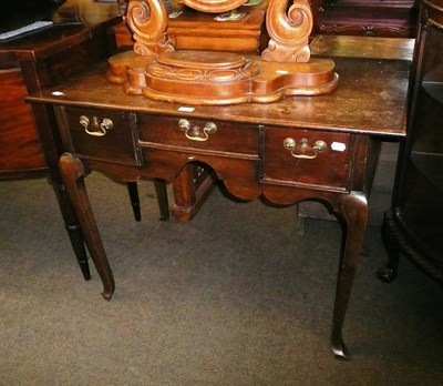 Lot 596 - An 18th century oak three drawer side table