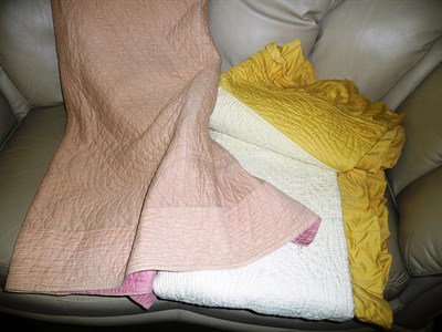 Lot 630 - A pink Durham quilt and a yellow Durham quilt