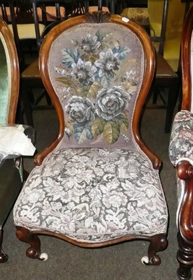 Lot 633 - A Victorian walnut spoon back nursing chair