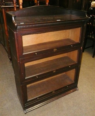 Lot 666 - A dark stained oak stacking bookcase