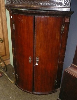 Lot 678 - Georgian mahogany bowfront corner cupboard