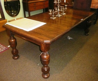 Lot 693 - An oak telescopic dining table with two extra leaves