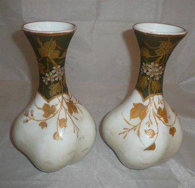 Lot 11 - A pair of glass vases of wrythen form decorated with flowers