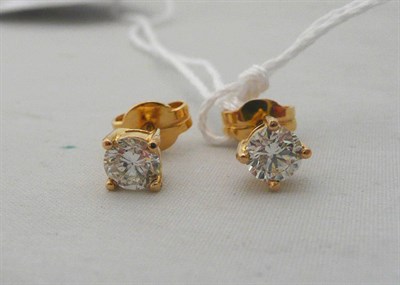 Lot 60 - A pair of diamond solitaire stud earrings