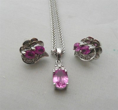 Lot 72 - A pink sapphire and diamond pendant on chain and a pair of earrings