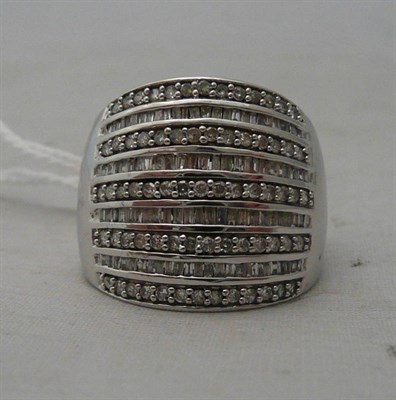Lot 85 - A 9ct white gold multi-row baguette and brilliant cut diamond ring