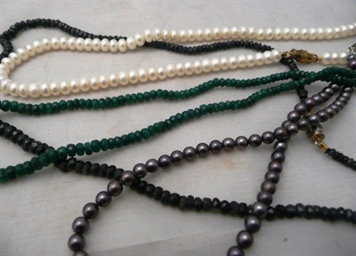 Lot 89 - Two strands of cultured pearls, a strand of faceted emeralds and one of sapphires