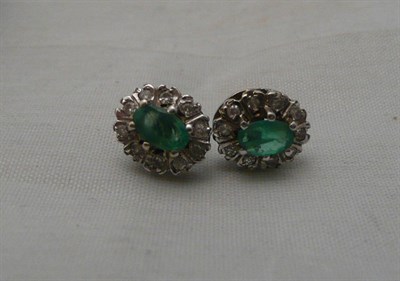 Lot 103 - A pair of 9ct gold, emerald and diamond cluster earrings