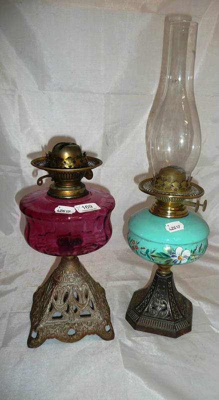 Lot 169 - Cranberry oil lamp and a green oil lamp